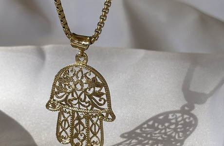 A huge silver or gold Hamsa necklace
