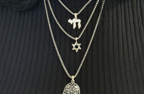 A huge silver or gold Hamsa necklace